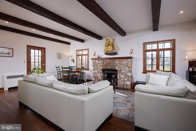 living area featuring dark wood finished floors, radiator heating unit, beamed ceiling, french doors, and a fireplace