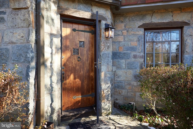 entrance to property with stone siding