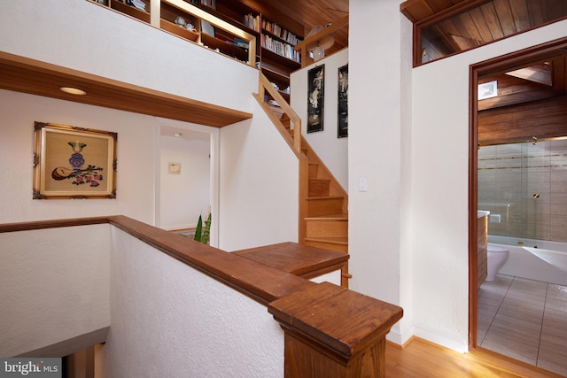 hall featuring stairs and wood finished floors