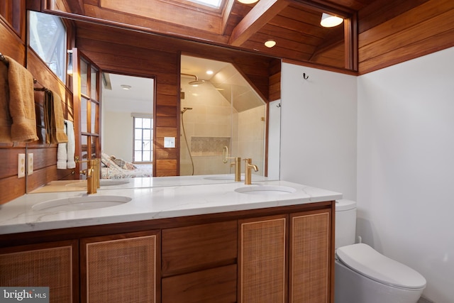 bathroom with double vanity, a stall shower, a sink, and toilet