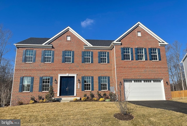 view of front of home with a garage and a front lawn