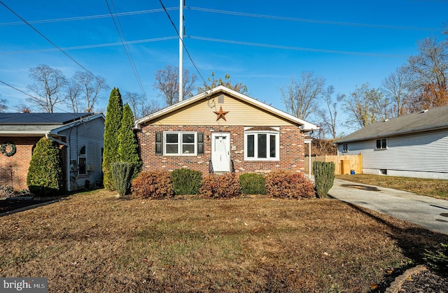 bungalow-style house featuring a front yard and brick siding