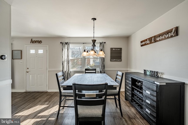 dining area featuring dark wood finished floors and baseboards