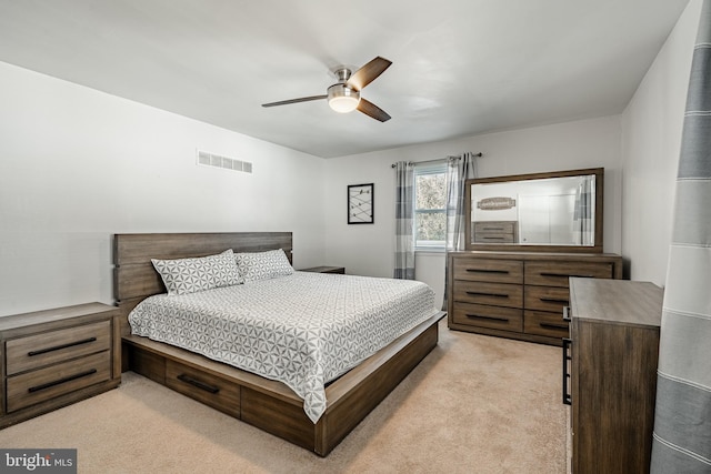 bedroom featuring light carpet, ceiling fan, and visible vents