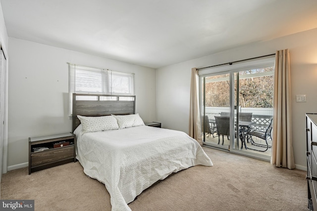 bedroom featuring access to outside, light colored carpet, and baseboards