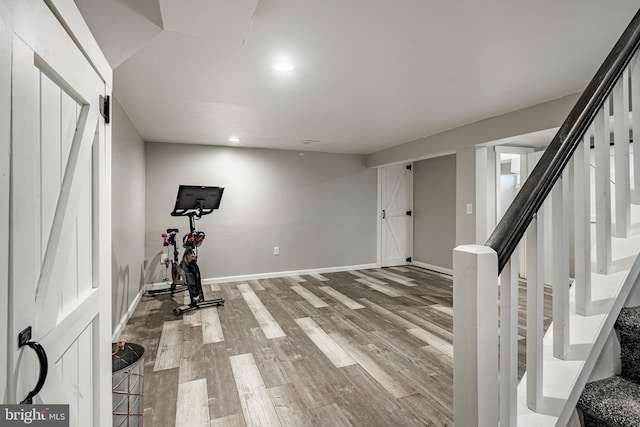 exercise room with recessed lighting, wood finished floors, and baseboards