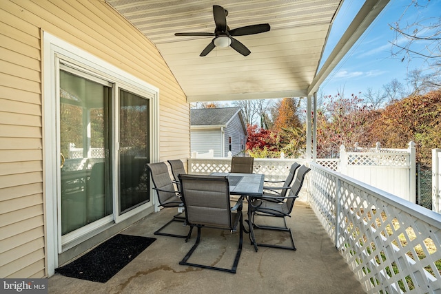 view of patio featuring ceiling fan, outdoor dining space, and fence