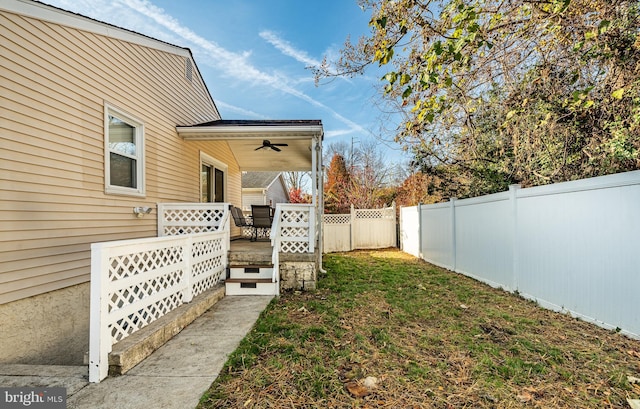 view of yard with a fenced backyard, a ceiling fan, and a patio