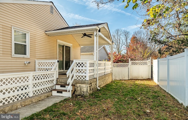 exterior space featuring a fenced backyard and ceiling fan