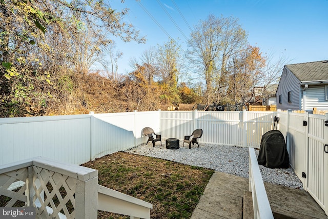 view of yard with a fenced backyard and a fire pit