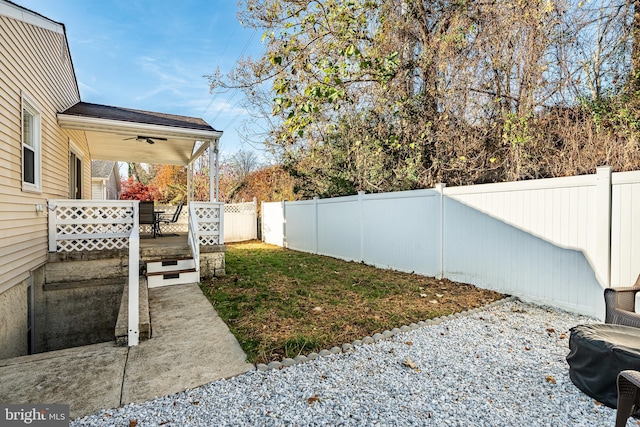 view of yard with a patio area, a fenced backyard, and ceiling fan