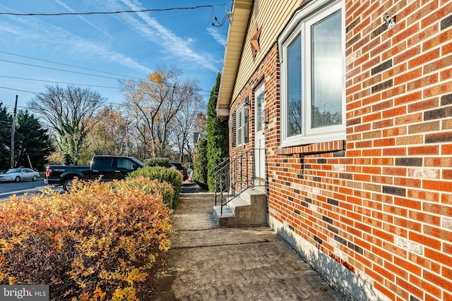 view of side of home featuring brick siding