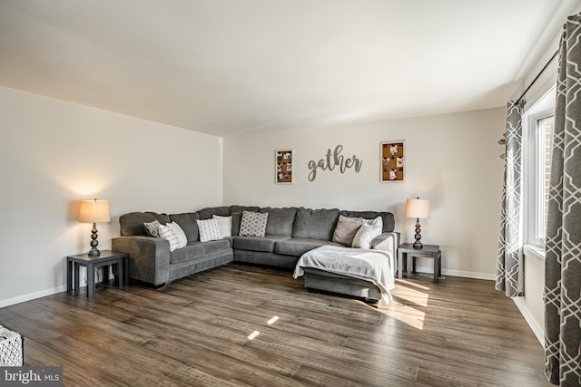 living room with dark wood-type flooring and baseboards