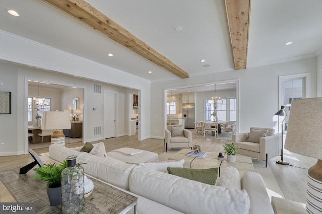 living room featuring an inviting chandelier, light wood-style flooring, beamed ceiling, and visible vents