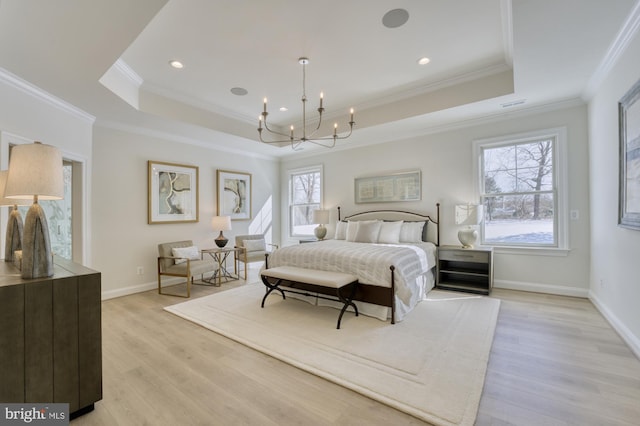 bedroom featuring a raised ceiling, multiple windows, a chandelier, and light wood-type flooring