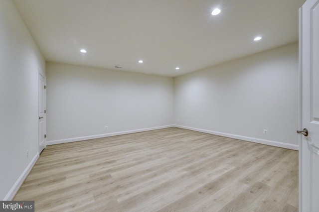 spare room featuring baseboards, light wood-style flooring, and recessed lighting