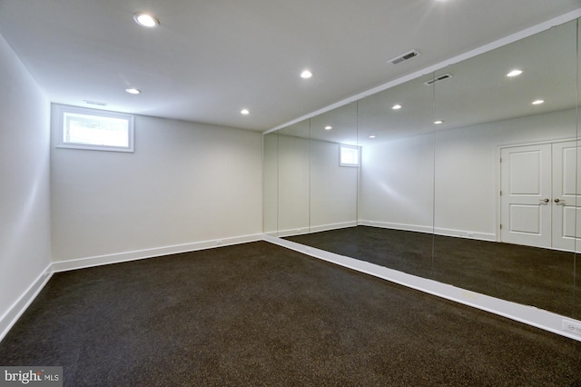 below grade area featuring carpet flooring, recessed lighting, and visible vents