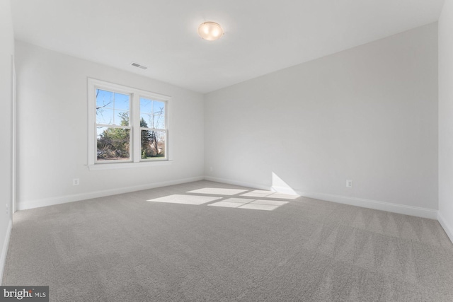 carpeted empty room with baseboards and visible vents