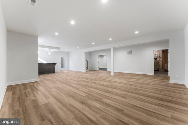 unfurnished living room with light wood finished floors, baseboards, visible vents, and recessed lighting