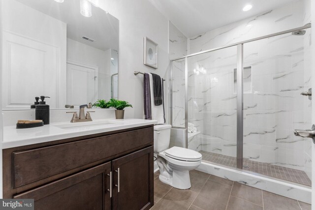 full bathroom with visible vents, toilet, vanity, and a marble finish shower