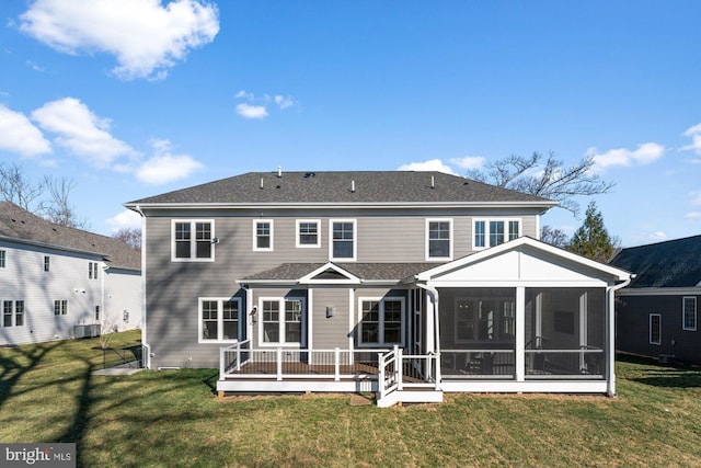 back of house featuring central air condition unit, a lawn, a sunroom, and roof with shingles