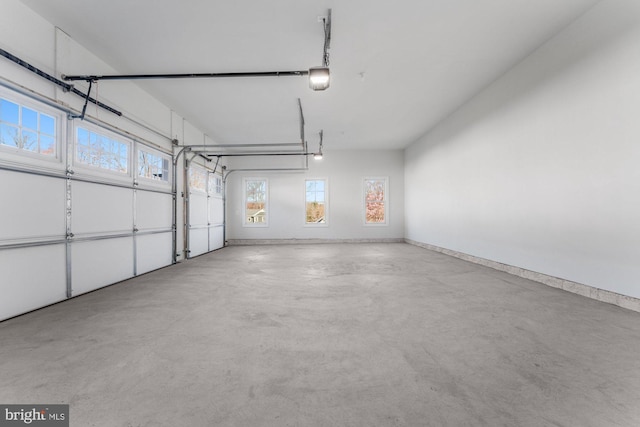 garage with baseboards and a garage door opener