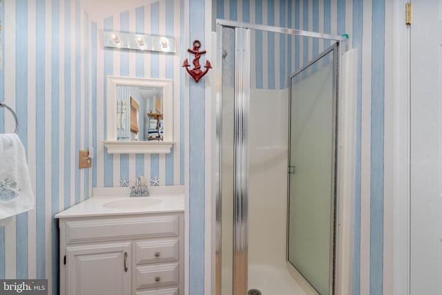 bathroom with a shower with door and vanity