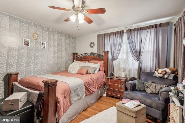 bedroom with ceiling fan and wood-type flooring