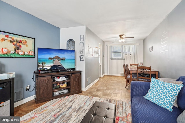 living room featuring ceiling fan and light parquet floors