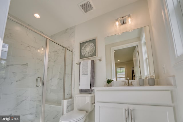 full bathroom featuring toilet, a marble finish shower, visible vents, and vanity