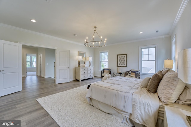 bedroom with light wood-type flooring, baseboards, multiple windows, and a chandelier