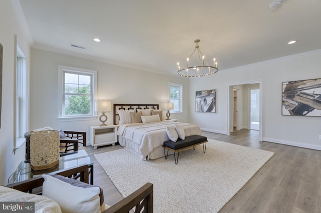 bedroom featuring light wood-style flooring, multiple windows, visible vents, and baseboards