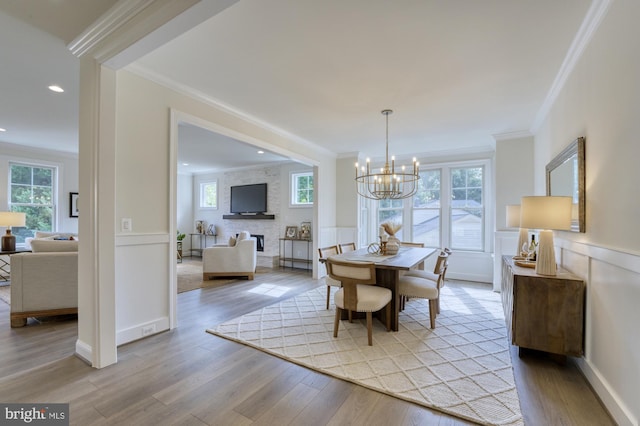 dining room featuring plenty of natural light, wainscoting, and light wood-style flooring