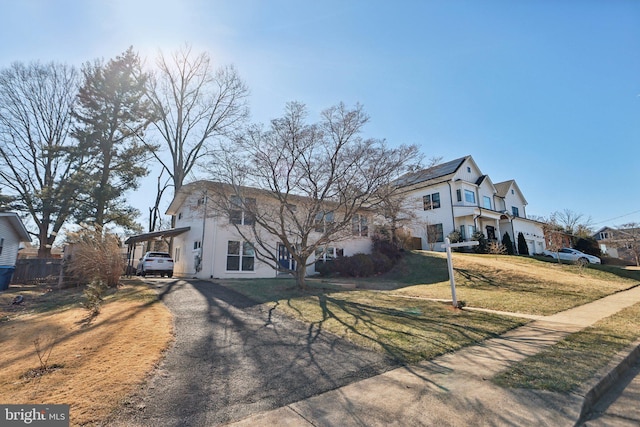 view of front facade with a front lawn and a carport