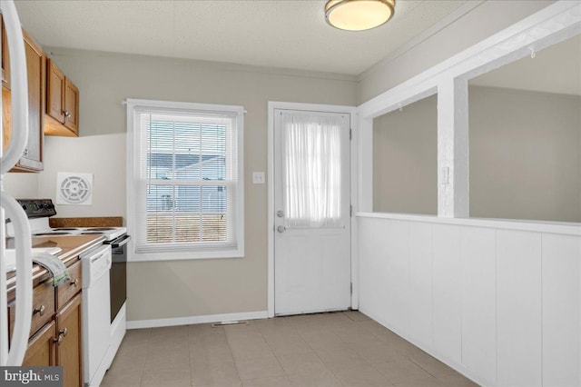 kitchen featuring stove and a textured ceiling