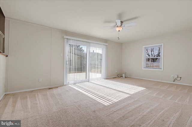 spare room with light colored carpet and ceiling fan