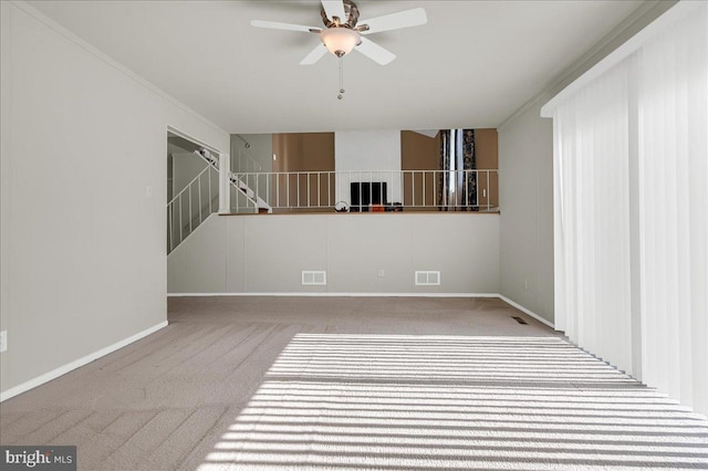 empty room with carpet floors and ceiling fan