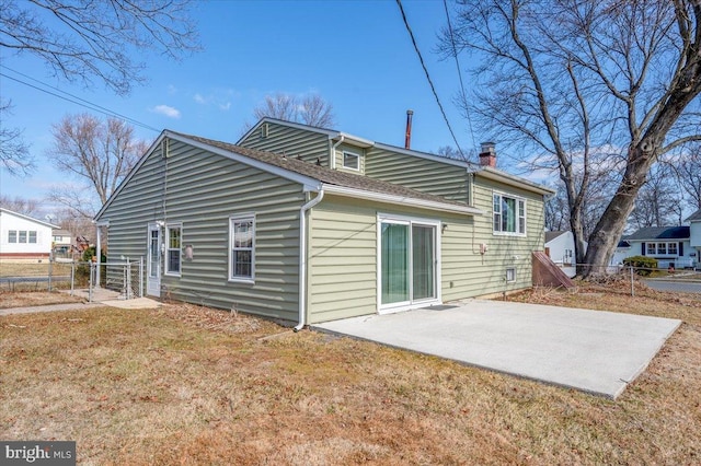 rear view of house with a patio area and a lawn