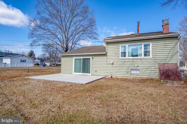 rear view of property featuring a yard and a patio area