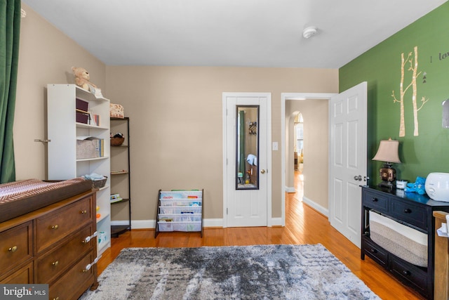 bedroom featuring baseboards and wood finished floors