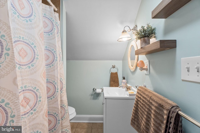 full bathroom featuring lofted ceiling, toilet, vanity, baseboards, and tile patterned floors