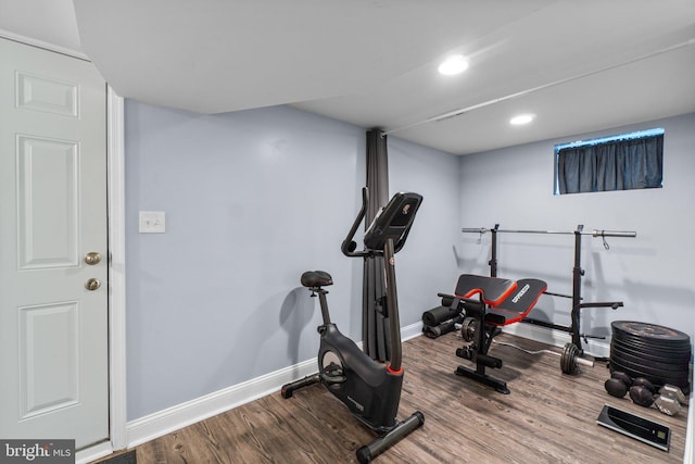 workout area with baseboards, wood finished floors, and recessed lighting