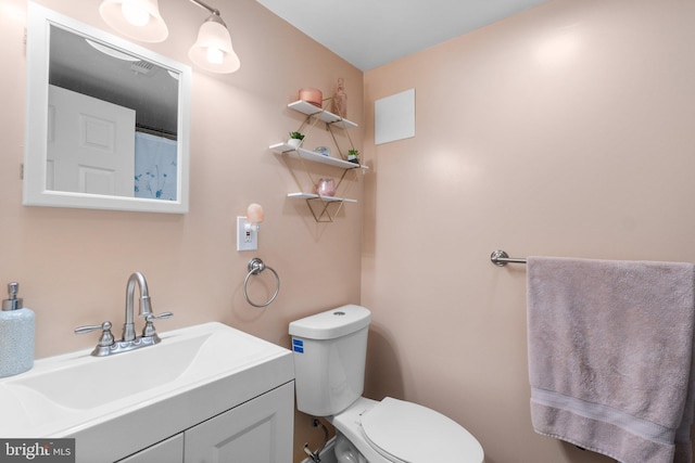 bathroom featuring vanity and toilet