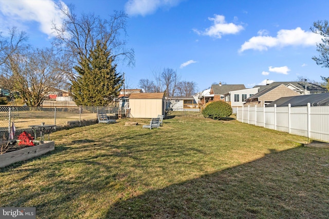 view of yard featuring a fenced backyard, a storage unit, and an outbuilding