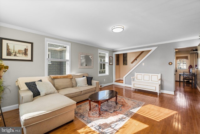 living area featuring crown molding, wood-type flooring, a wealth of natural light, and baseboards