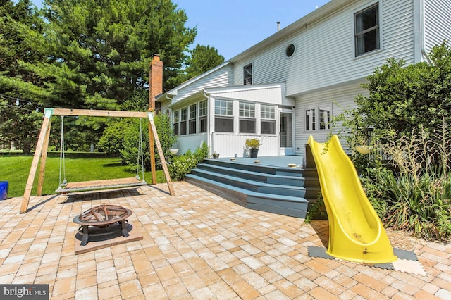 9238 English Meadow Way, Gaithersburg, MD 20882 - view of patio / terrace featuring a playground, a sunroom, an outdoor fire pit, and a deck