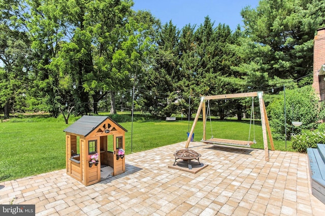 9238 English Meadow Way, Gaithersburg, MD 20882 - view of patio with an outdoor fire pit, view of wooded area, and a playground