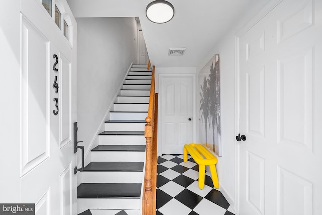 stairs featuring visible vents and tile patterned floors