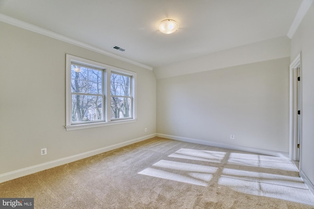 empty room featuring baseboards, visible vents, crown molding, and light colored carpet