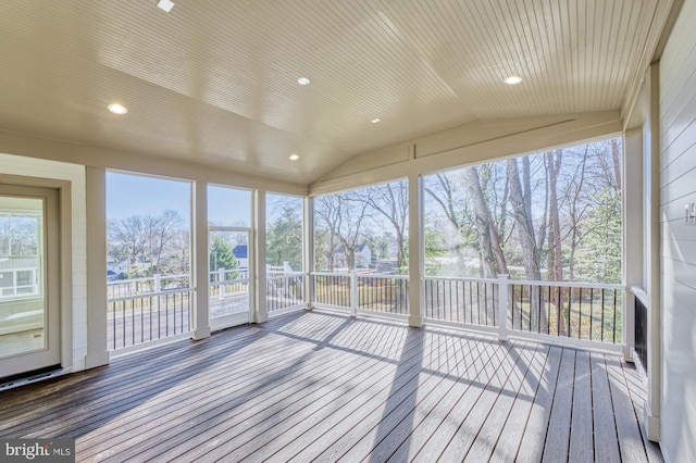 unfurnished sunroom featuring lofted ceiling and wood ceiling